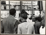 German civilians study the weekly photo news exhibit of the American-printed Regenburg Post in Straubing.