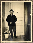 Mr. Lowenthal stands in the entrance to his home in Aachen; a Jewish star is affixed to the door.