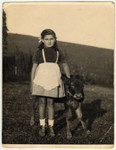Rina Willer stands next to a young calf while in hiding in the Croatian countryside after escaping from the Rab internment camp.