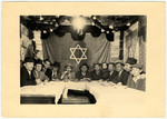 Jewish men gather in a communal sukka in the Amberg displaced person's camp.