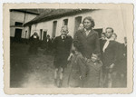 Two Jewish brothers stand in front of the Polish maid who is hiding them in the Belgian countryside.