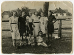 Group portrait of woman and children standing outside in Warsaw before the war.
