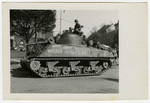 An American tank drives down a street in Pilsen, Czechoslovakia on liberation day.