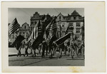 American soldiers march through Pilsen, Czechoslovakia on its liberation day.
