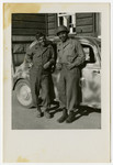 Two African American US soldiers pose in front of a car in Pilsen, Czechoslovakia on its liberation day.