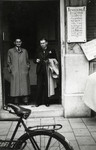 Ephraim Rosenbaum, along with his brother Sallie, stands at the entrance to the government office where he went to register the birth of his daughter Betty