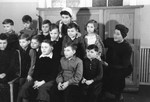 Group portrait of children and caregivers in a postwar children's home in Niedershoenhausen Berlin.