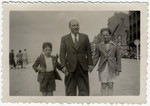 Kurt Frost, an Austrian Jewish boy who came to Belgium on a Kindertransport, walks down the street with his foster family.