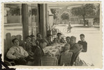 Teenagers from Les Murailles children's home eat a final ice cream in an outdoor cafe in Geneva prior to leaving Switzerland on Youth Aliya.