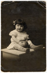 Studio portrait of a young girl holding a ball, an unidentified relative of Regina Goldberg.