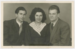 Sziku Smilovic (left) poses for a studio portrait with his sister and brother-in-law, Heddy and Arthur Spitz, prior to their immigration to the United States.