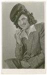 Studio portrait of Heddy Smilovic (later Spitz) smoking a cigarette.