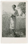 Close-up portrait of Vilma Eisenstein Grunwald standing in front of a wheat field,.