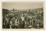A group of survivors get off transport trucks on arrival [probably at the [Eisenach displaced persons camp.]

The original caption reads, "They unload and get deloused and there is much confusion and they are human beings with hopes."