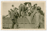 A group of survivors climb aboard a truck transporting them out of the Buchenwald conentration camp after its liberation.