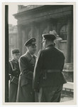 Alfred Rosenberg shakes hands outside the French National Assembly.