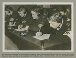 Hitler Youth members are photographed during a radio operator's exam.