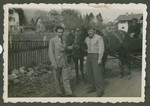 Herman Kutun (right) poses next to a horse drawn cart with a DP, probably in or near Garmisch.