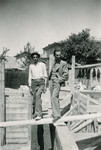 Architect Moshe (Buky) Finci and another man pose at a construction site.