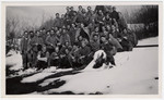 Group portrait of Jewish internees posing in the snow in an unidentified Swiss labor camp.