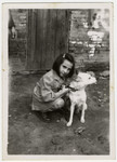 Helga Schneider poses with her dog Bobby on a street in Shanghai.