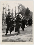 German soldiers and their families surrender to Allied troops.