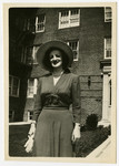 Jewish survivor Sali Bogatyrow poses for a photograph before an unidentified apartment block.