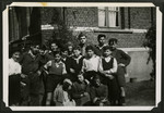 David Marcus poses with a group of Jewish children in Marquain, Belgium.