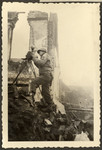 An American soldier takes photographs of the destroyed town of Herzogenrath.