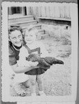 Sharona Gorelitz holds a chicken while posing for a photograph with her mother Pnina "Pepa" Adlerstein.