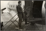 Joseph Eaton boards an airplane [perhaps en route to the Middle East].