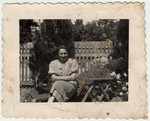 Etel Gruenstein Brand and [probably her mother] sit outside in a sunny garden.