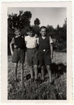Alfred and Ernst Moritz pose with their friend Georges in a field in France after the war.