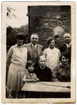 Prewar portrait of the Moritz family seated by an outdoor table in Becherbach.