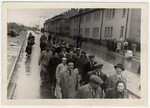 Jewish displaced persons march through the streets of the Bergen Belsen camp.
