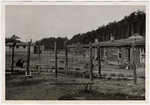 View of the fence and barracks in the Woebbelin concentration camp.
