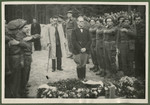 Belgian soldiers and the mayor of Lueneburg pay their final respects to the 243 slave laborers who were shot by their guards on the railway lines at Lueneburg on the way to the Belsen Camp.