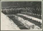 Under the supervision of British troops, German civilians and Nazi officials pay hommage to the graves of 243 slave laborers who were shot by their guards on the railway lines at Lueneberg on the way to the Belsen Camp.