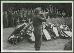 A bugler plays taps at a memorial service for the 243 slave laborers who were shot by their guards on the railway lines at Lueneburg on the way to the Belsen Camp.