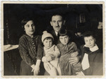 Simon Bloch poses with his four children gathered around him.