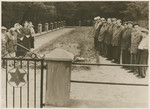 Lithuanian survivors gather next to a mass grave in Inkakliai, Lithuania.