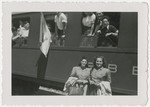 Hungarian Zionists who had come to Switzerland with the Kasztner transport pose inside and outside a train adorned with a Zionist flag.