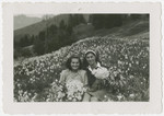Eva Weinberger (left) and a friend pose in a field of wild flowers in Castella di Trevano.