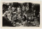 Passengers on board the Exodus relax and eat a meal while en route to Palestine before the British navy intercepted the ship.