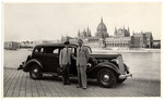 Swiss Consul General, Carl Lutz, poses with his driver, Charles Szluha, along the bank of the Danube River across from the parliament building in wartime Budapest.