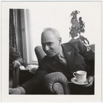 Close-up portrait of Maurice Levitt holding a coffee cup in the UNRRA House in Lindenfels.