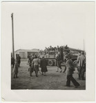 A group of children from a displaced persons crowds onto a truck.