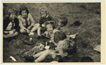 Young children enjoy an ice cream picnic.

David Marcus' original caption reads: "Ice cream, dougnuts, and happy faces."