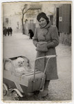 Shanke Minuskin takes her baby son Henik for a walk in his baby carriage through the streets of Zhetel.