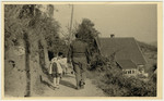 An aid worker accompanies a column of children on their walk [probably in Lindenfels].